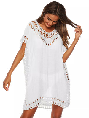 White crochet V-neck cover-up dress with intricate details and short sleeves.