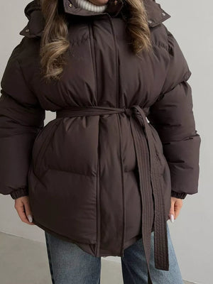 Dark brown belted puffer trench coat with hood and quilted detail.