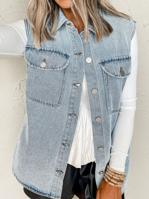 Medium wash oversized denim utility gilet with collared neckline and button front.