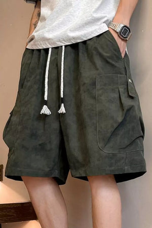 Relaxed fit military green cargo shorts with drawstring waist and large side pockets.