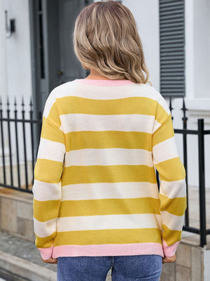 Striped knit sweater with yellow, white, and pink details.