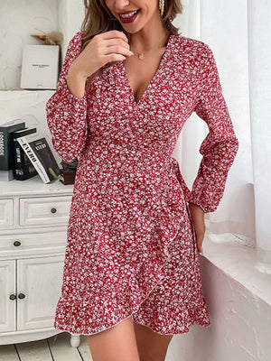 Red floral wrap mini dress with V-neck, long sleeves, and ruffled hem.