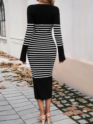 Black and white striped knit midi dress with flared sleeves and a solid black hem.