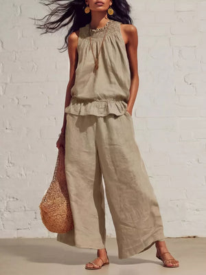 Khaki smocked peplum top and flowing pants set with ruffled hem and wide legs.