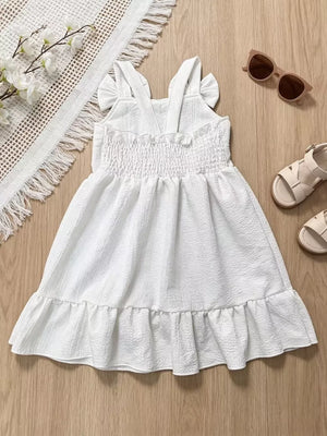 White baby dress with smocked bodice, ruffle straps, and ruffled hem.