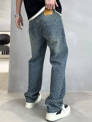 Relaxed fit blue denim jeans with allover textured pattern and a leather patch.