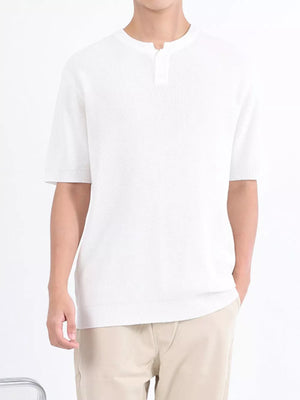 Men's white textured knit short sleeve henley with button placket and ribbed trim.