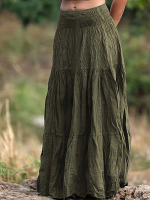 Green tiered maxi skirt with smocked waist and crinkled fabric detail.