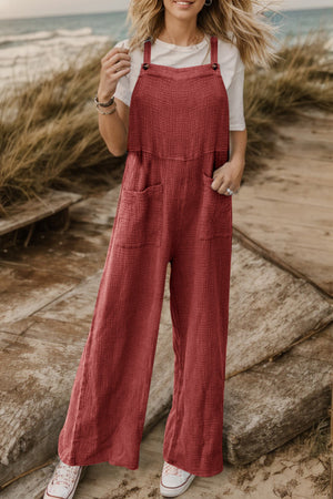Rust textured cotton overalls with square pockets and wide legs.