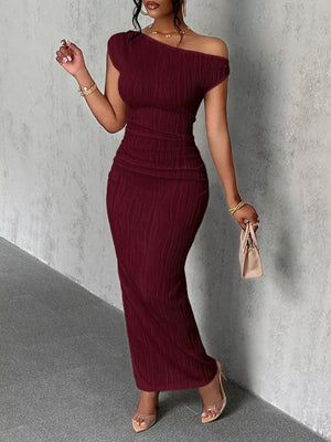 Wine red textured one-shoulder maxi dress with ruched detail and asymmetrical neckline.