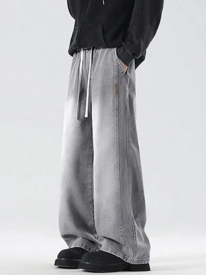 Oversized drawstring washed denim jeans in cement gray with a relaxed fit.