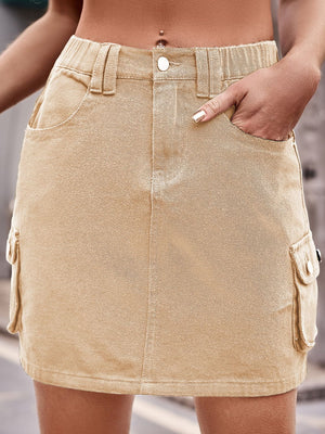 Khaki denim utility mini skirt with cargo pockets and button closure.