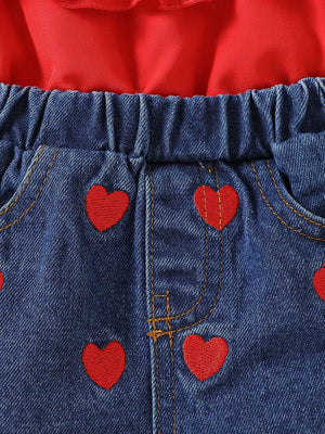 Red ruffled top with denim shorts featuring red heart embroidery