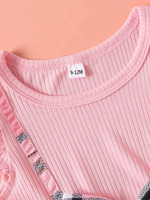 Pink ribbed baby dress with cap sleeves and geometric trim detail.