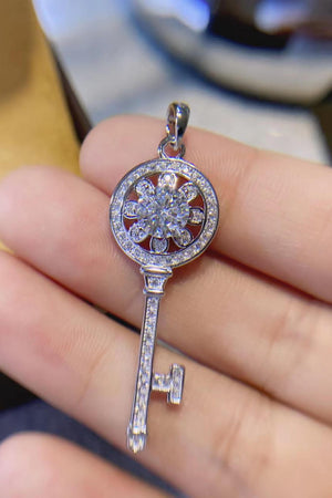 Silver key pendant necklace with floral diamond accent and pave set diamonds on stem.