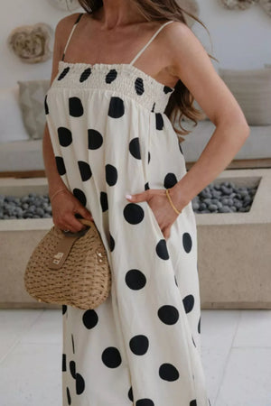 Charming cream polka dot maxi dress with pockets and smocked bodice.