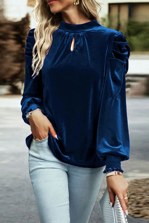 Velvet keyhole puff-sleeve blouse in dark blue with smocked cuffs.