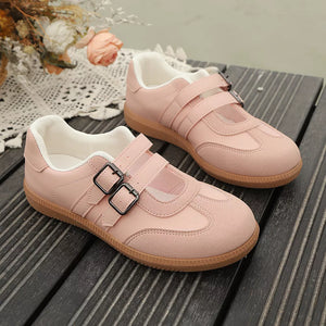 Pink buckle strap Mary Jane inspired sneakers with double buckle detail and suede accents.