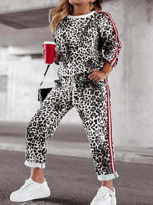 Leopard print two-piece set with white and red striped trim, drawstring waist pants, and crew neck top.