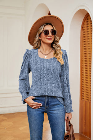 Textured pastel blue blouse with square neckline and cuffed sleeves