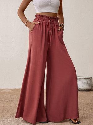 Ruffled waist palazzo trousers in rust with a drawstring and wide legs.
