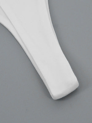 White flowy maxi dress detail showing wide strap and hem.