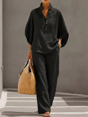 Chic black button-down loungewear set with a stand collar and wide sleeves.