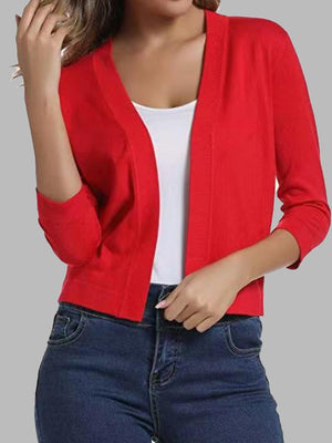 Red cropped knit cardigan with elbow sleeves and open front, styled with a white tank top and jeans.