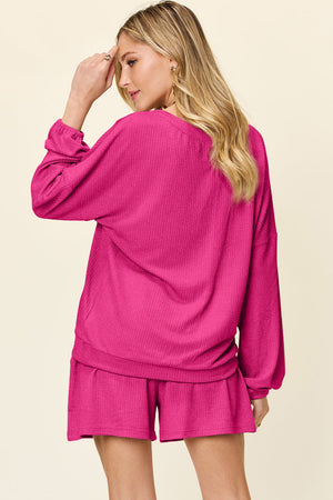 Hot pink waffle knit lounge set with blouson sleeves and shorts.