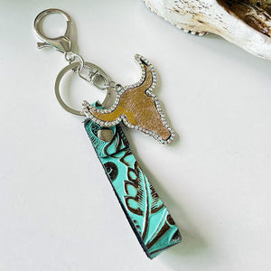 Embossed leather bull keychain with crystal accents and turquoise tooled strap.