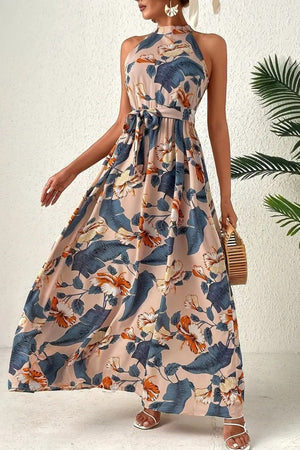 Halter neck maxi dress with floral print and tie waist, in tan with blue and orange flowers.