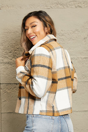 Camel plaid shacket with contrast collar and buttoned front, styled casually.
