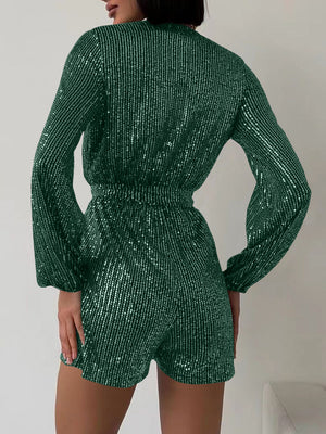 Dark green sequin wrap romper with blouson sleeves and cinched waist.