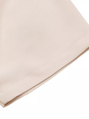 Apricot midi dress with V-neck and pleated detail, showing fabric texture.