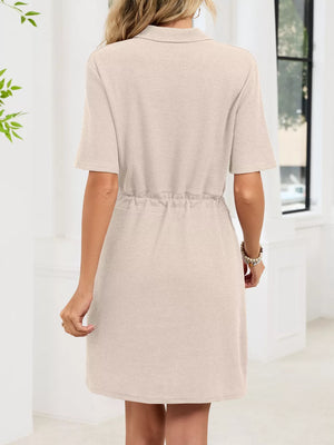 Textured polo dress in apricot with short sleeves and adjustable drawstring waist.