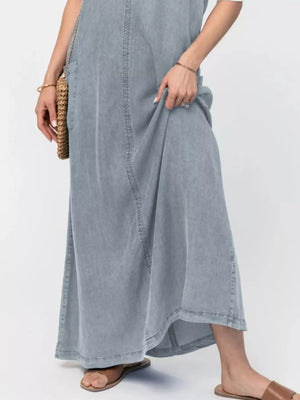 Light blue denim maxi dress with pockets and a relaxed fit.