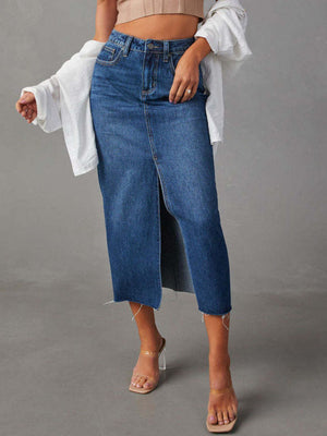 Medium wash denim midi skirt with raw hem and front slit.