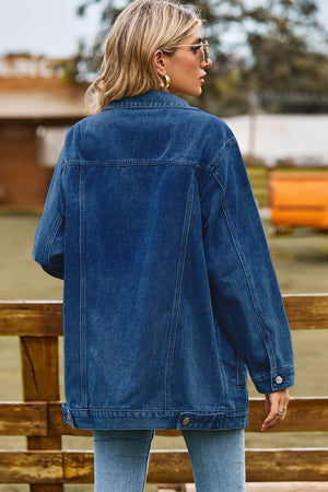 Oversized denim trucker jacket in medium blue with classic buttoned details.