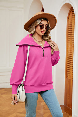 Fuchsia pink zip-through sweatshirt with wide collar and long sleeves.