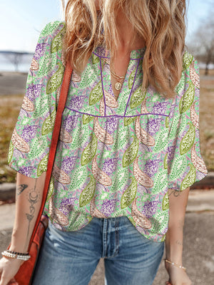 Paisley print puff sleeve blouse with V-neck and purple trim, in light green with purple and pink paisley.