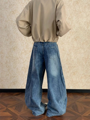 Men's blue washed cotton wide-leg jeans with a relaxed fit and distressed details.