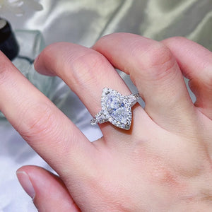 White marquise halo moissanite engagement ring with baguette and round accent stones.