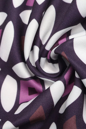 Maxi skirt with a vibrant geometric print in purple, white, and brown.