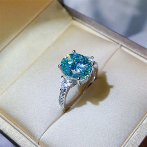 Turquoise moissanite trilogy ring in 925 sterling silver with oval and pear-shaped stones