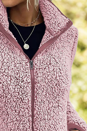 Teddy fleece zip-up jacket in dusty pink with a full zip and stand-up collar.