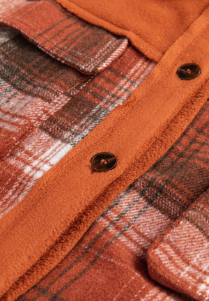 Colorblock plaid shacket in terracotta with contrast trim and button closure.