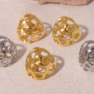 Gold and silver openwork orb rings with a contemporary, casual style.