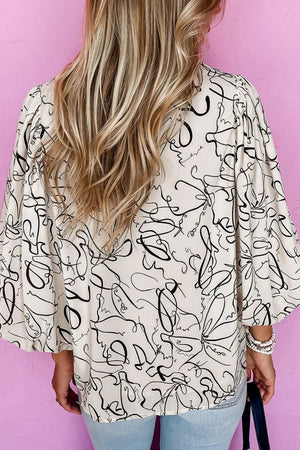 Ivory abstract scribble balloon sleeve blouse with a relaxed fit.