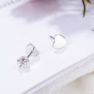 Elegant heart-shaped sterling silver stud earrings with butterfly backs