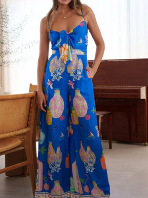 Blue tie-front wide-leg jumpsuit with architectural print and bow detail